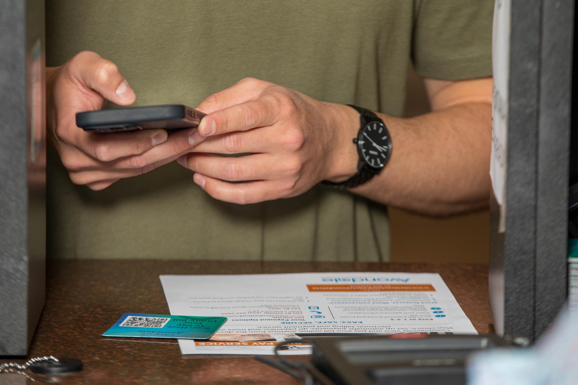Hand holding a black cell phone